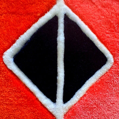 Focus sur les triangles centraux du coussin tufté